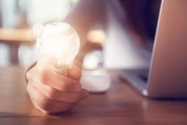 Hand holding a light bulb