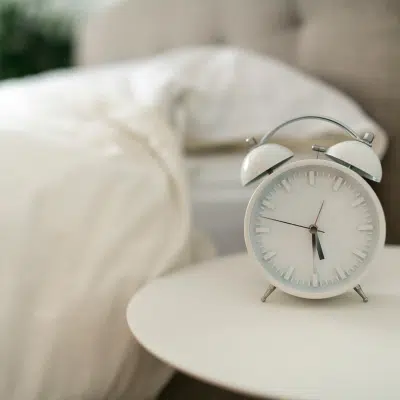 white clock on white nightstand