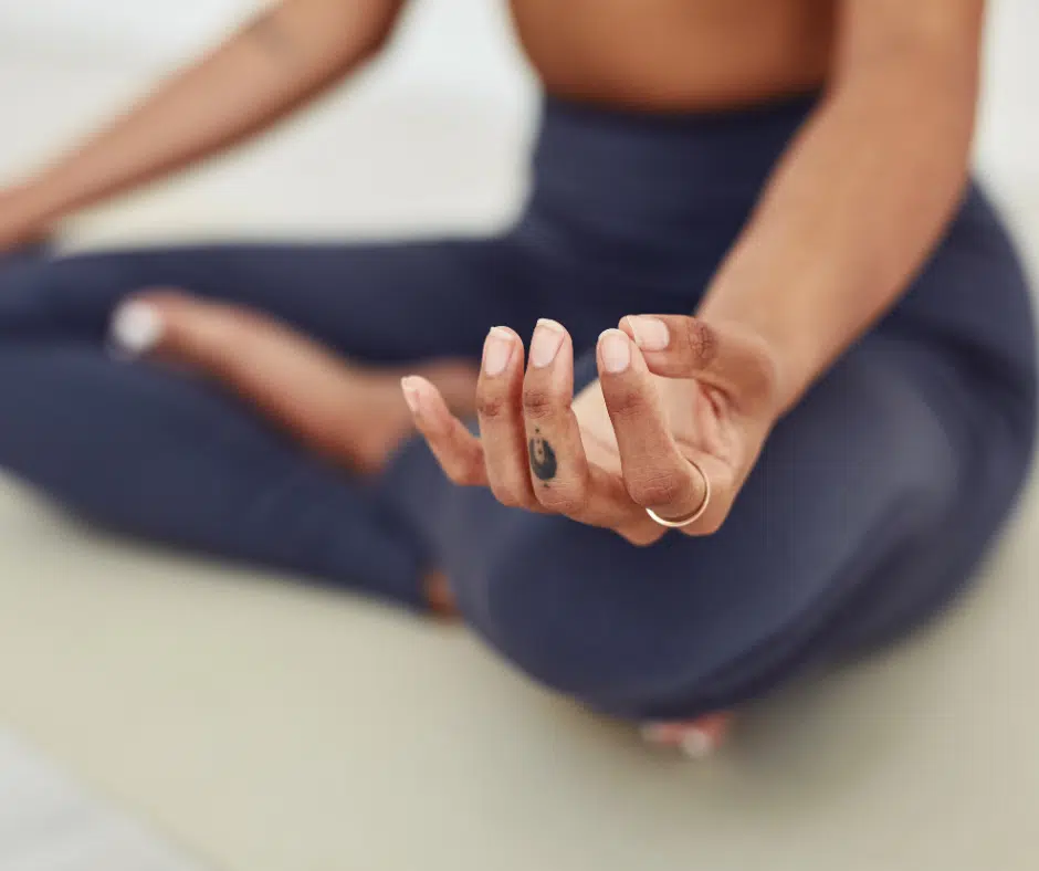 woman in meditative pose to reduce stress