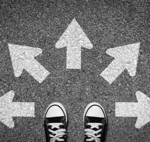 Picture of black and white converse sneakers standing in front of arrows pointing in different directions and meant to symbolize different choices a woman has for birth control