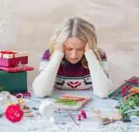 Woman stressing over holiday season gift wrapping